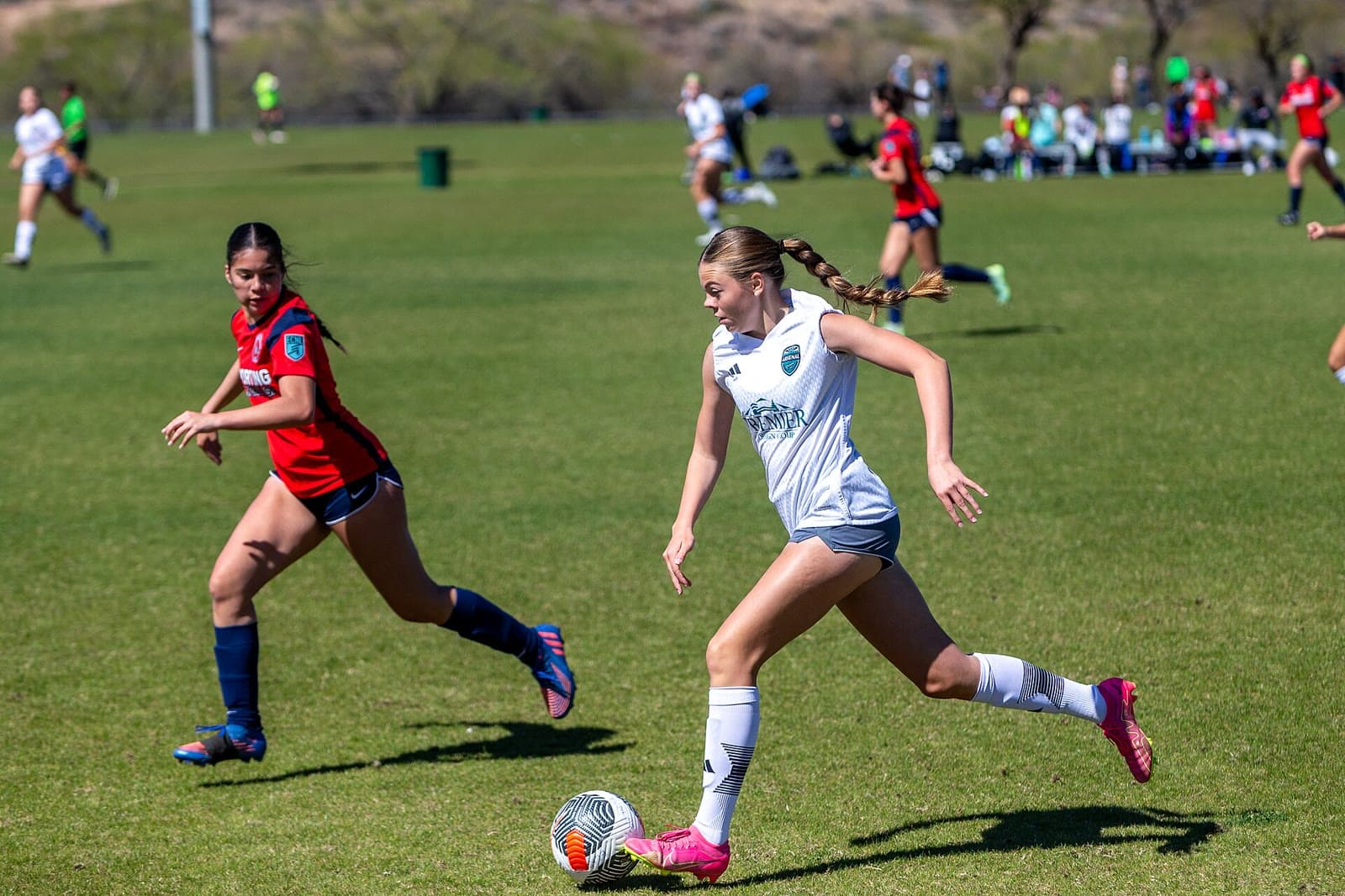 Youth soccer game in progress with players chasing the ball