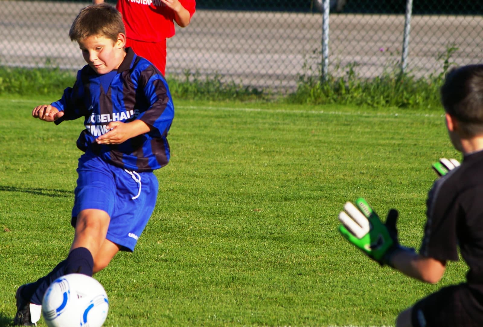 Youth footballers during a match challenging for the ball