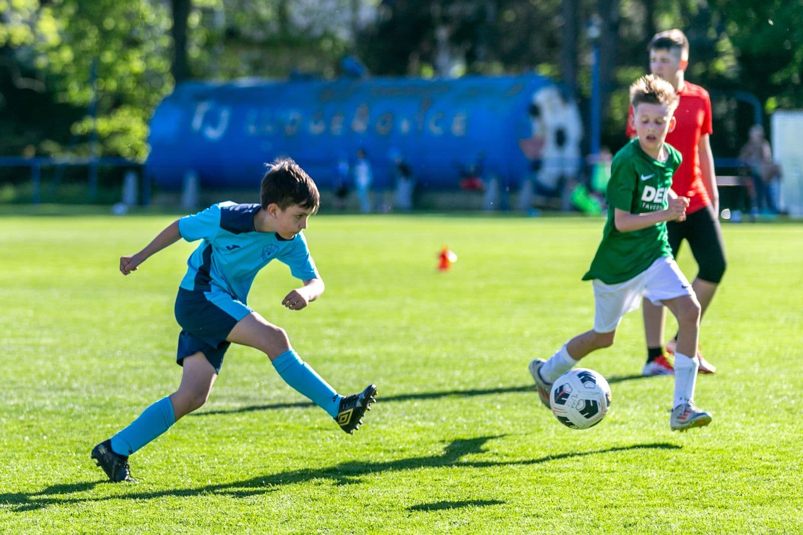 Youth football match, players challenging for the ball