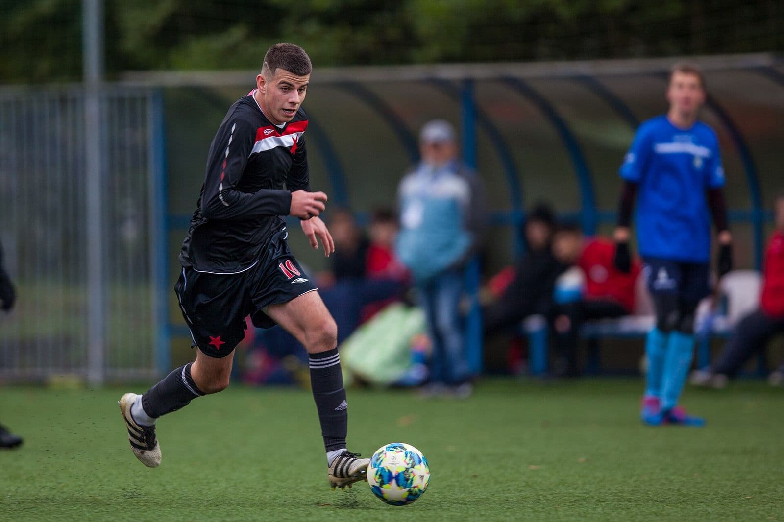 Two youth players challenging for the ball