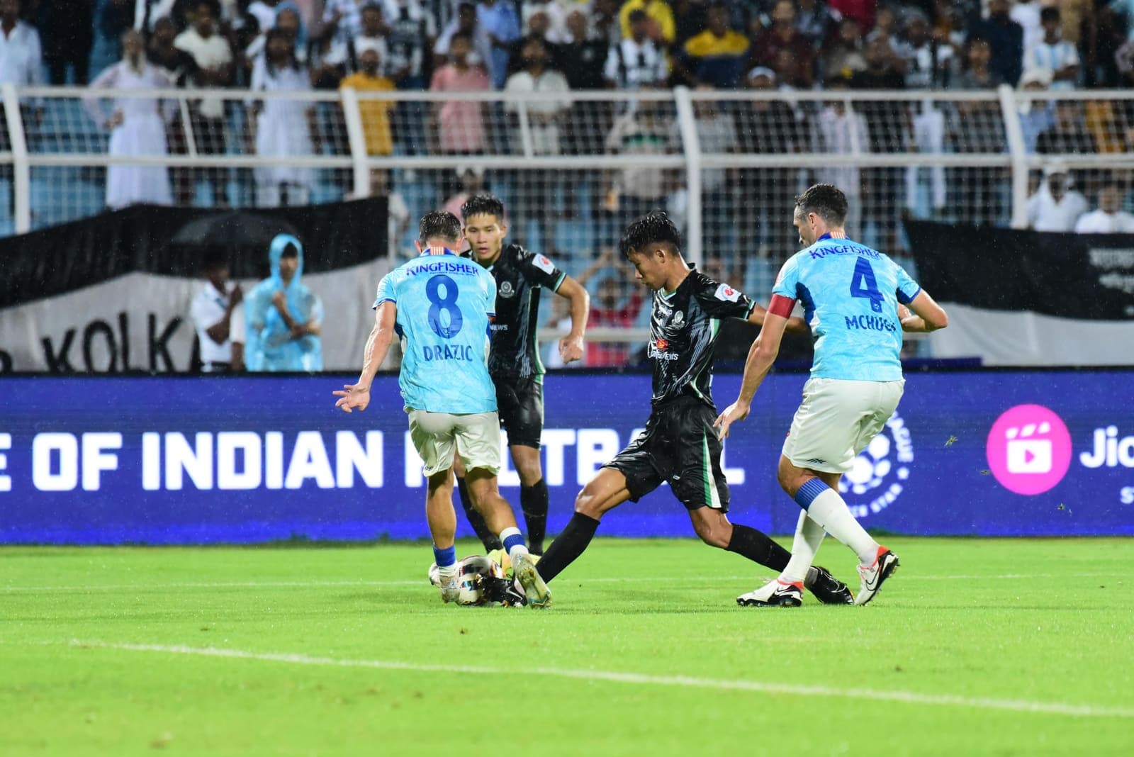 Indian footballer shielding the ball during a professional match in India