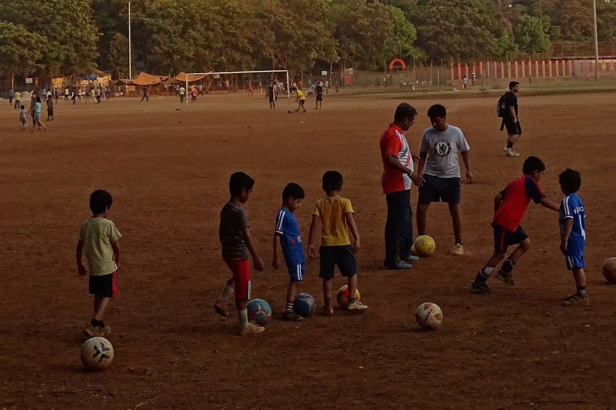 Boys playing football at Shivaji Park, Mumbai