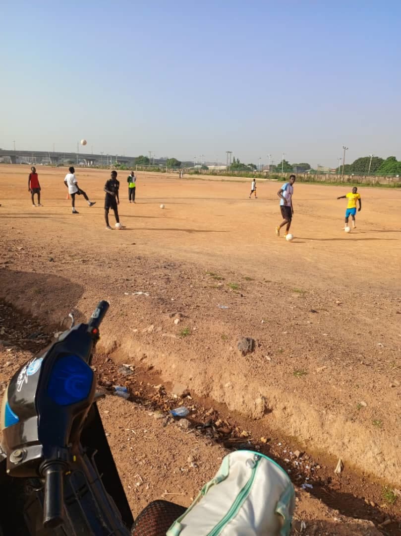 Youth football training with cones on a grass field