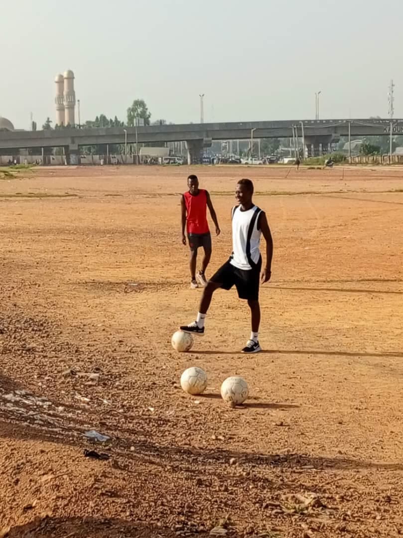 Youth football training session on a grass pitch