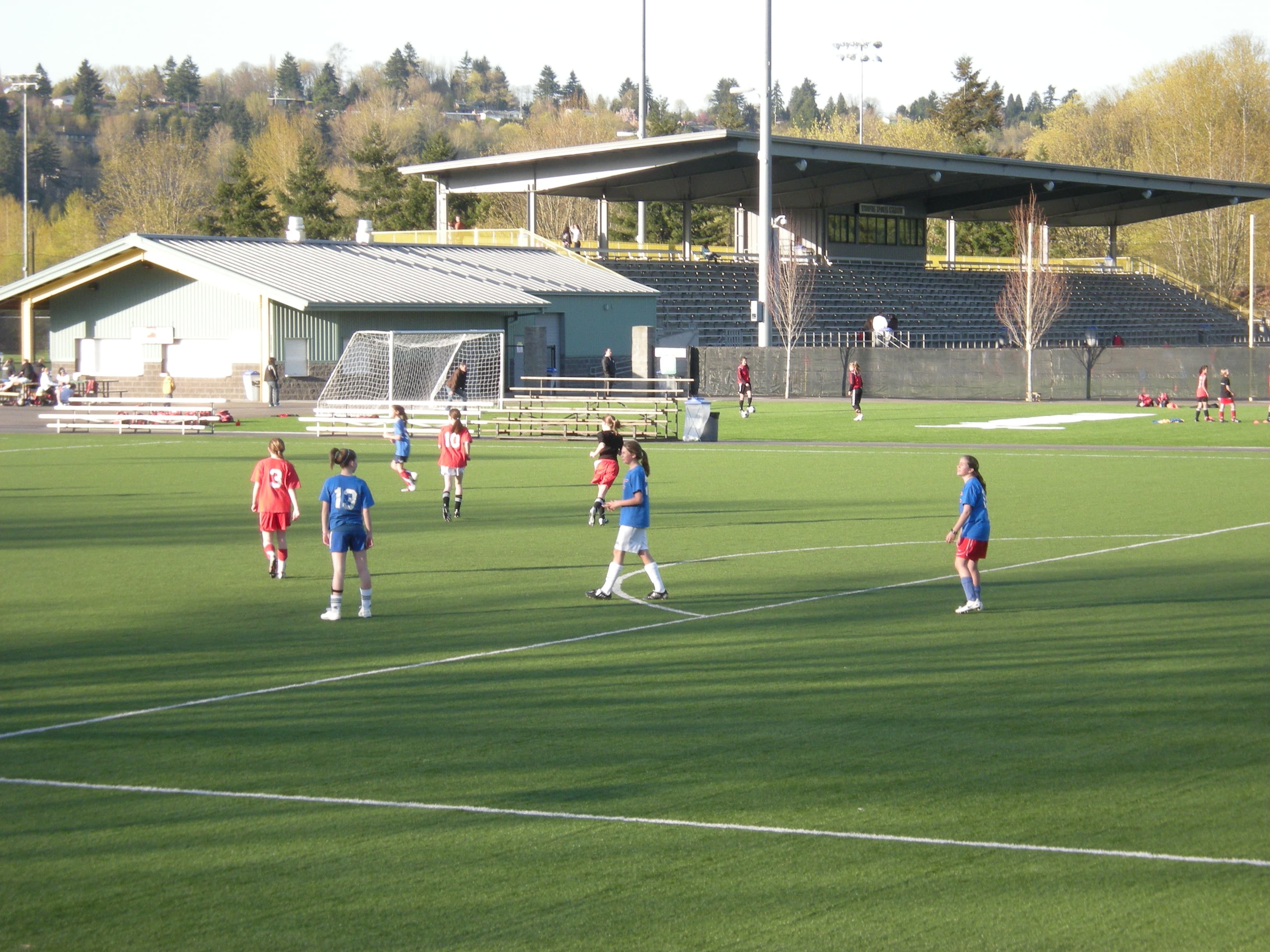 Girls playing football on a training pitch.