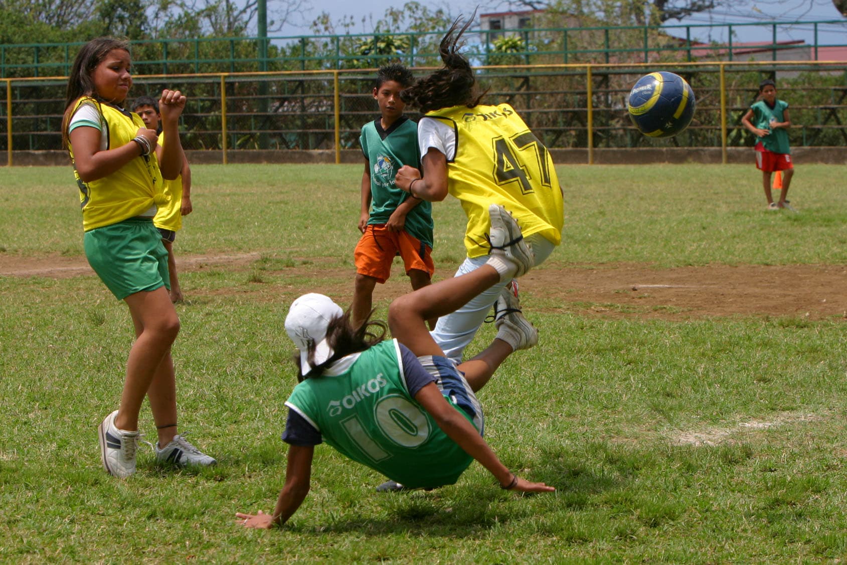 Indoor football training scene with players and ball.