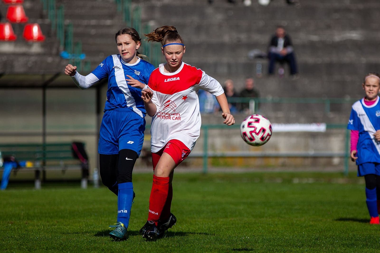 Two girls contesting the ball during a youth football match