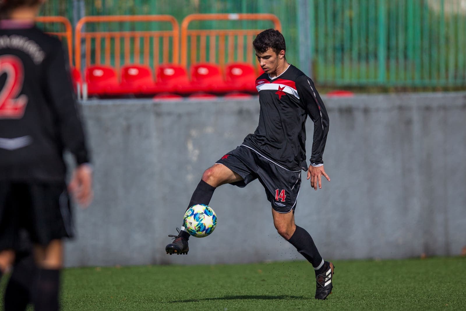 Youth footballer kicking the ball during a match