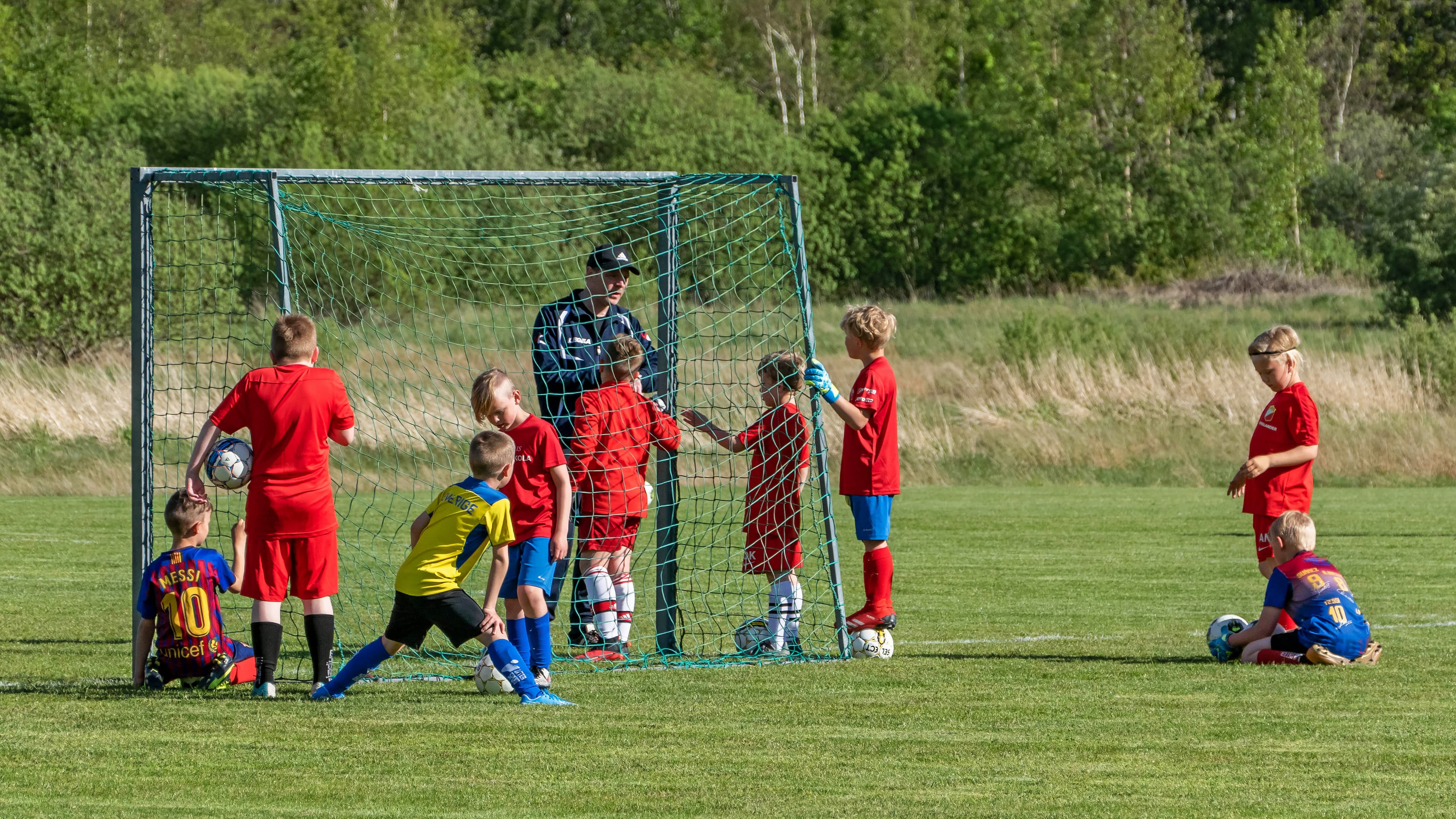 Youth footballers training at a community pitch.