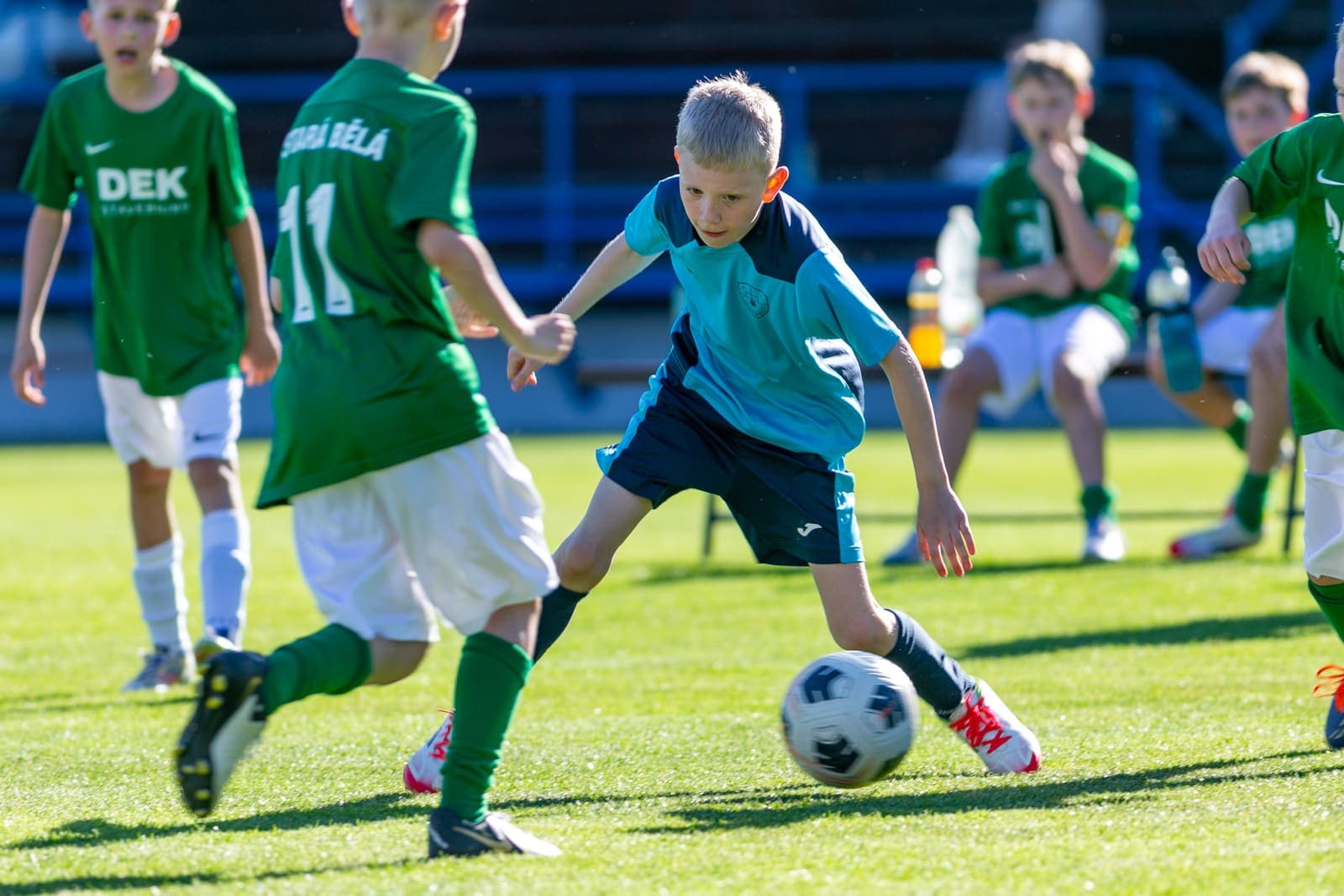 Young footballer dribbling the ball past an opponent