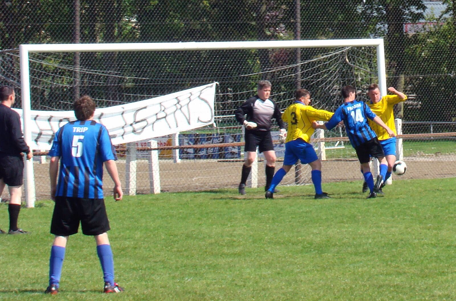 Dutch amateur football match action with players and a ball