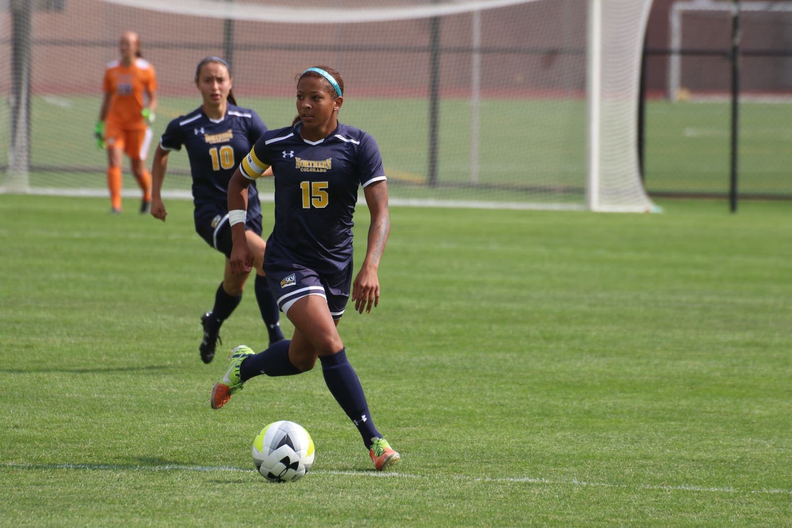 Women’s footballer dribbling the ball during a match