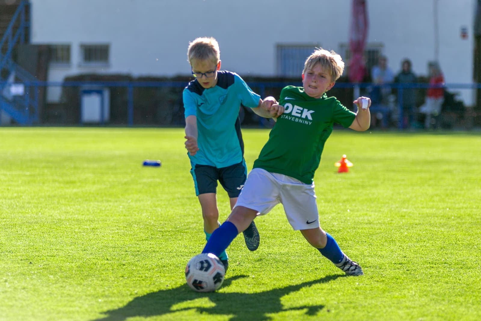 U11 youth football match with ball at feet