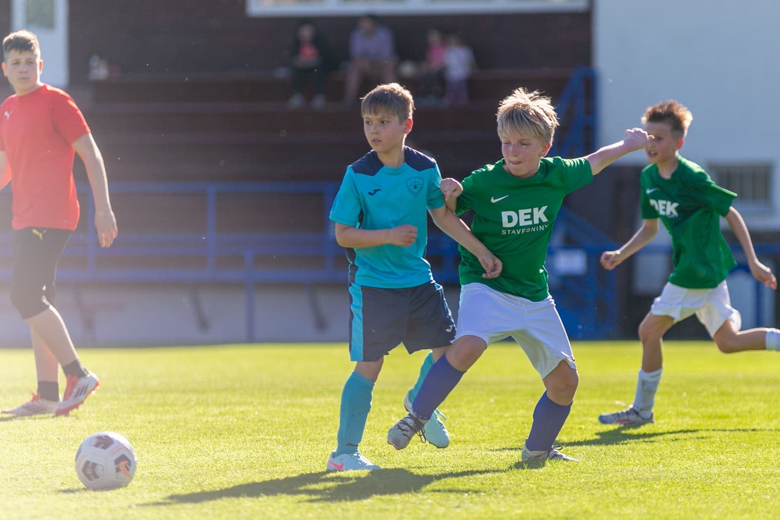 U11 footballers contesting the ball during a youth match