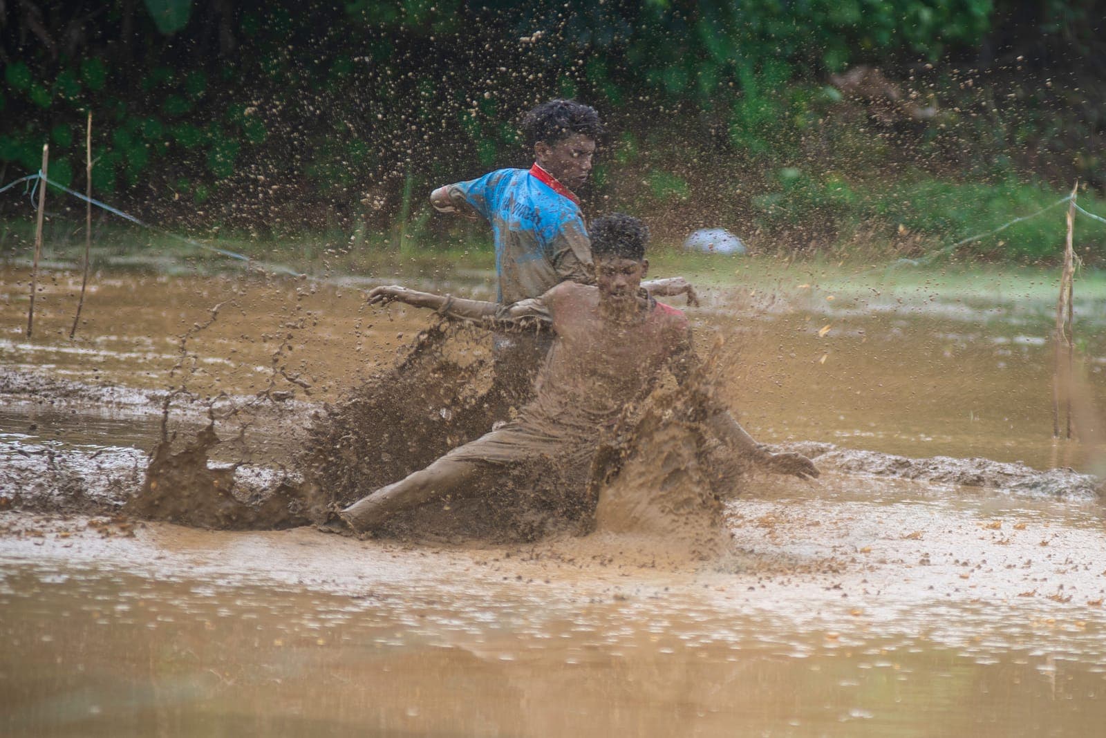 Mud football match in Kerala, India — players with ball