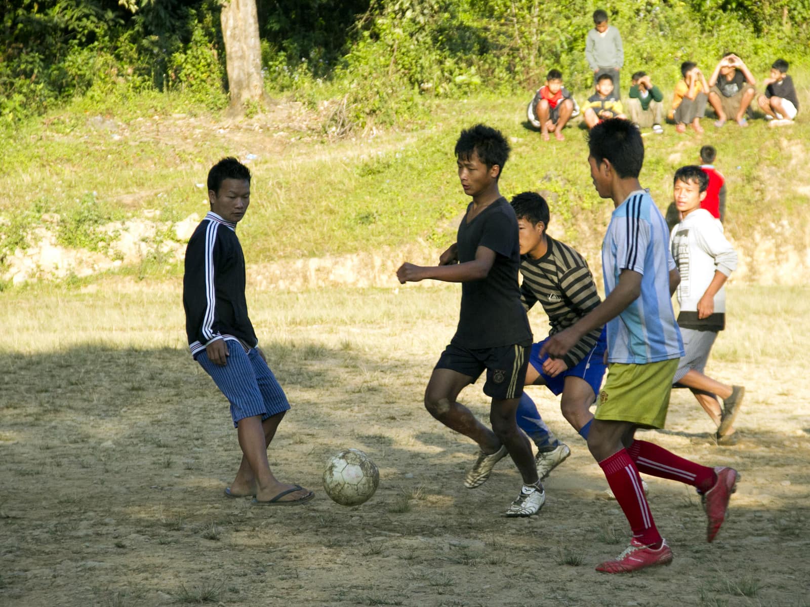 Informal football game in Manipur, India — players with ball