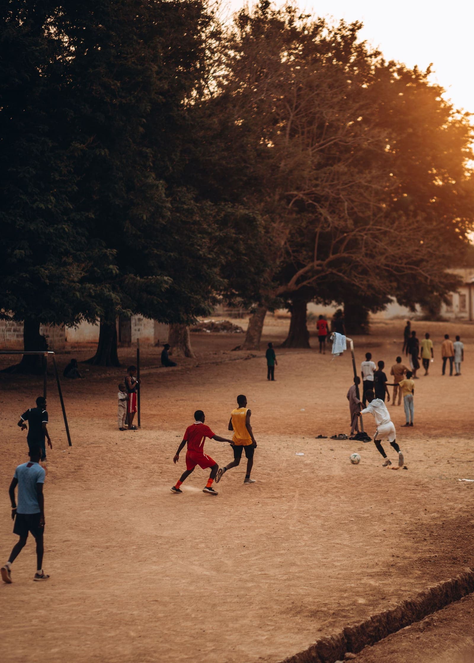 Kids playing football on a rustic Indian field