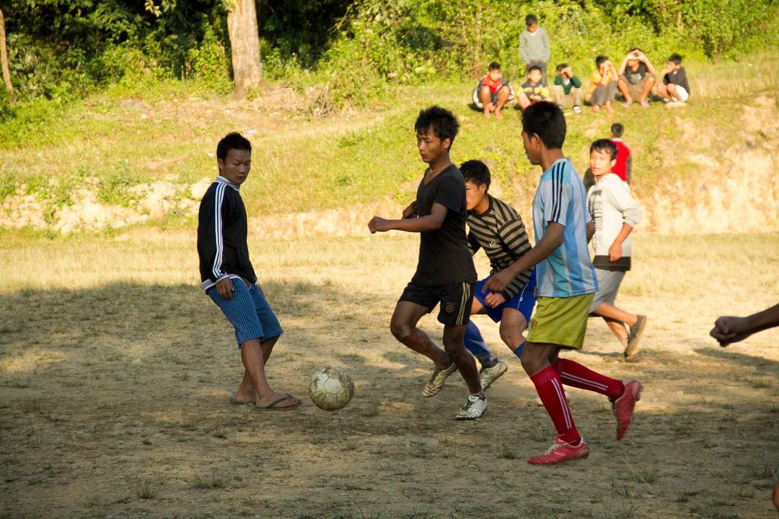 Informal football game in Manipur, India — players with ball