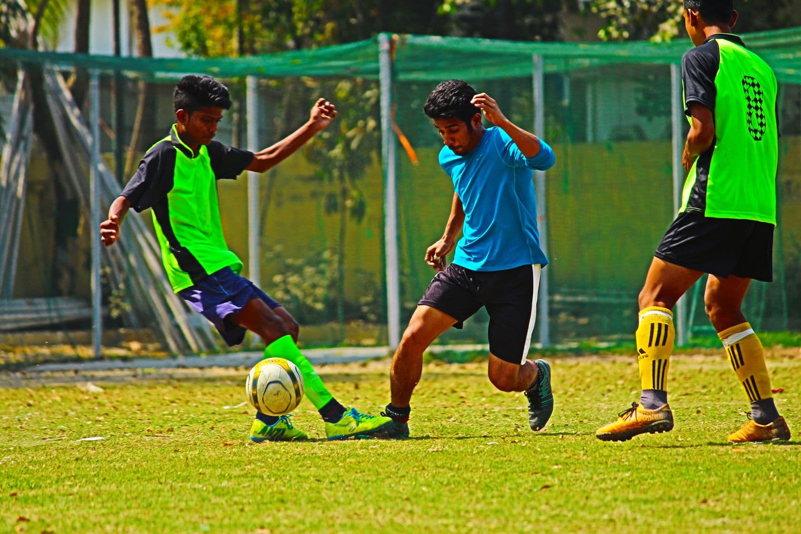 Football players on a field in India