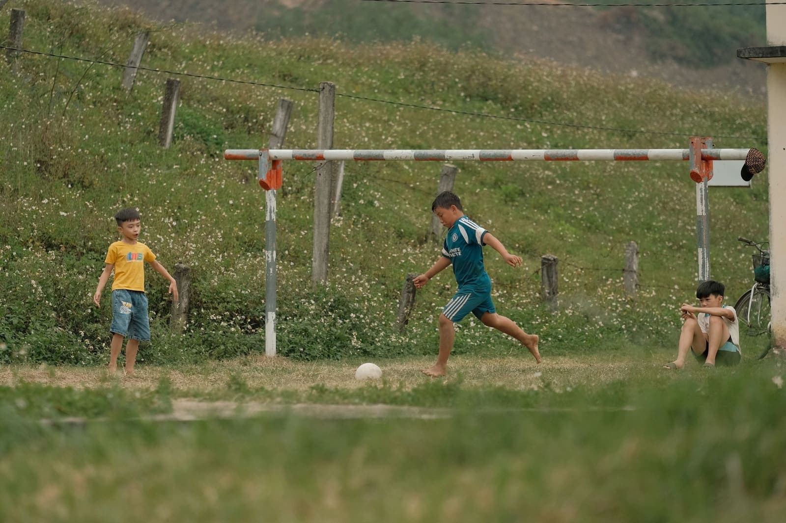 Children playing football on rural Indian field