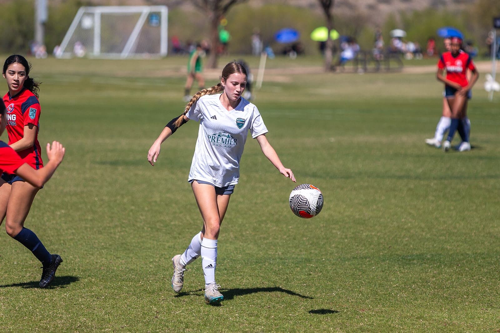 Youth soccer player dribbling during match