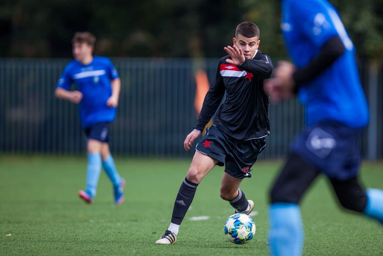 Youth footballer dribbling the ball during a match