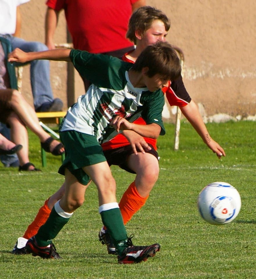 Youth footballer controlling the ball during a match