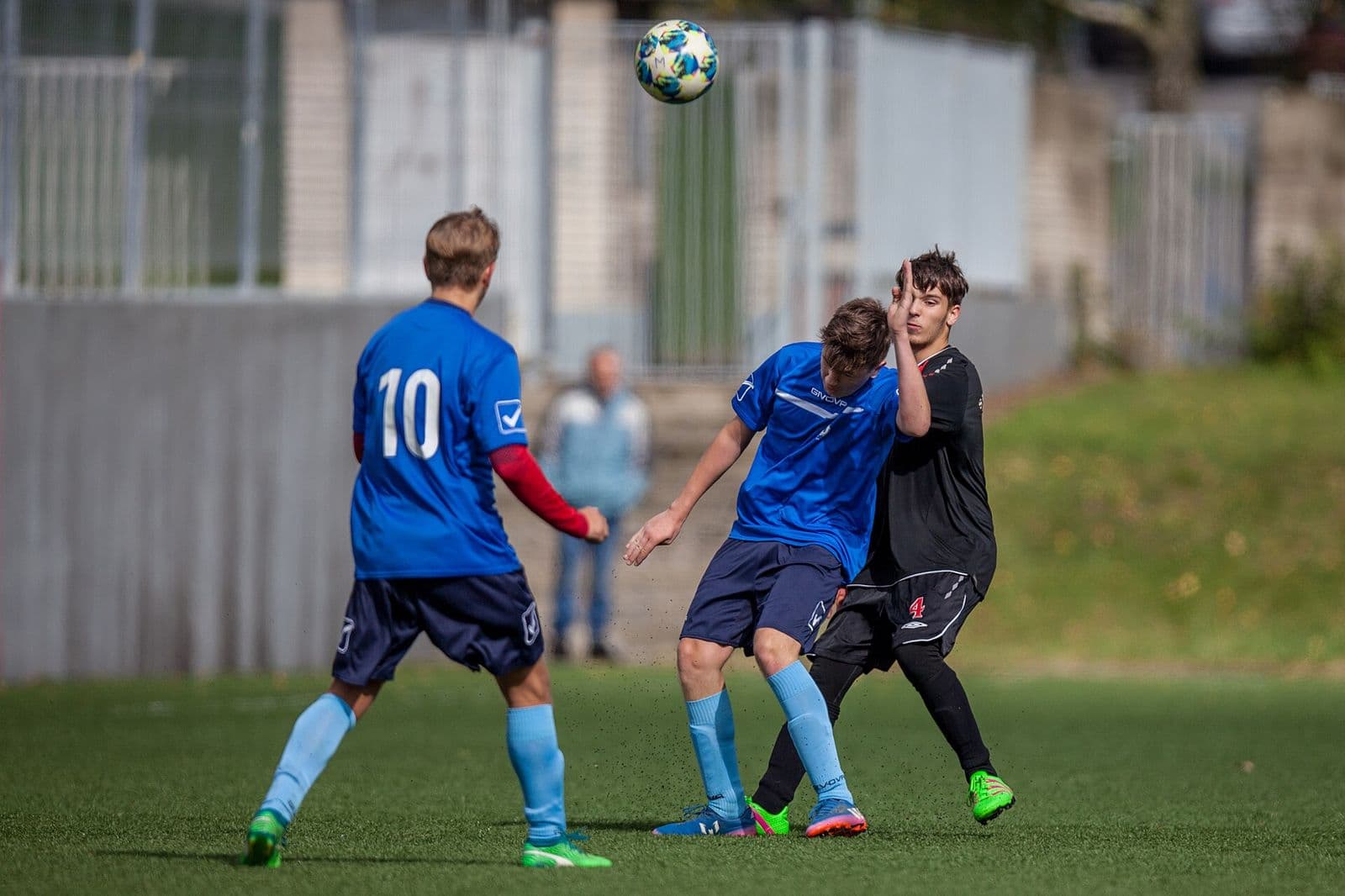 Youth football match action with ball in play