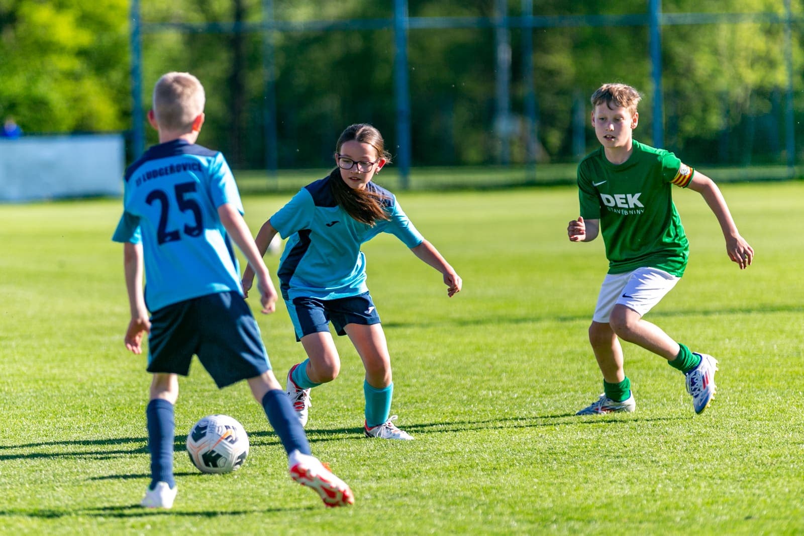 Youth footballers contesting the ball during a match