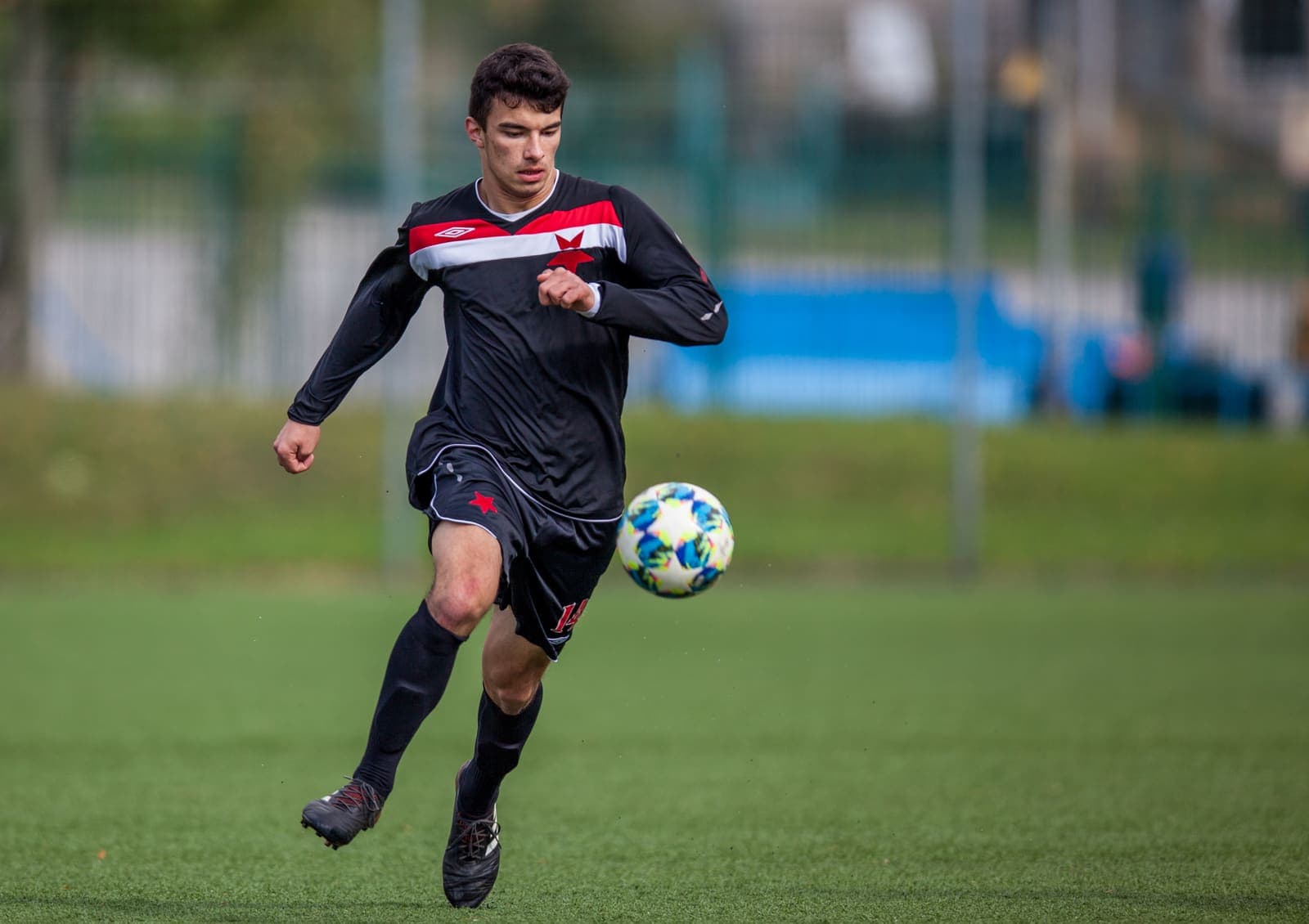 Footballer striking the ball during a match