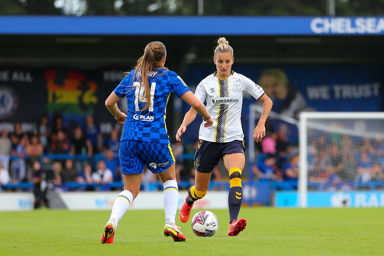 Two women’s footballers contesting the ball near goal