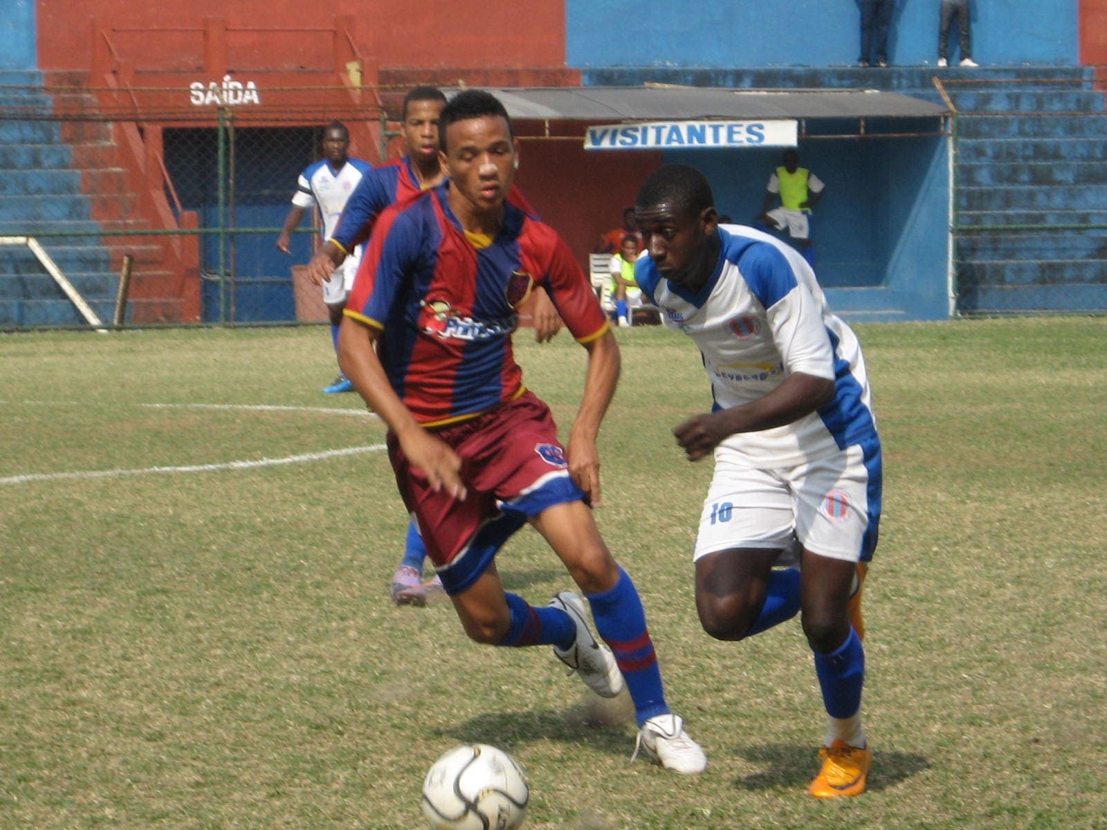 Two footballers contesting a dribble during a match