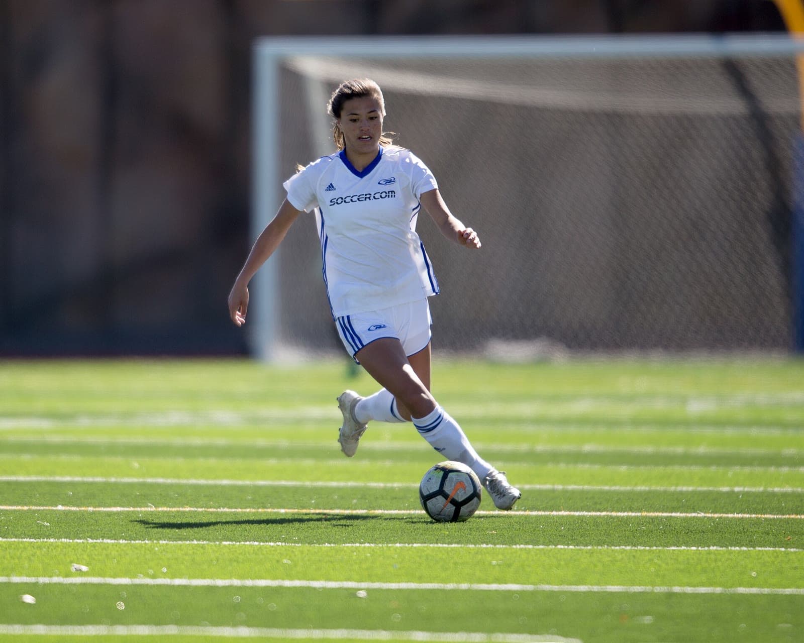 Youth player controlling the ball during a match