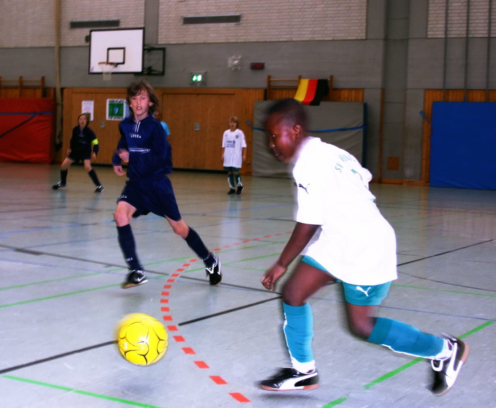 German youth indoor football — players and ball in action